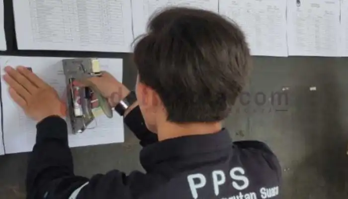 Petugas Panitia Pemungutan Suara (PPS) menempelkan DPSHP Pemilu 2024.