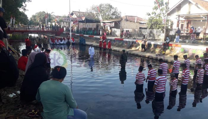 Warga Desa Pabian melaksanaan upacara bendera HUT ke-78 Kemerdekaan RI di Kali Marengan.