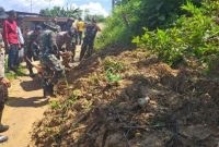 Personel Polsek Guluk-Guluk bersama TNI dan warga melakukan kerja bakti membersihkan material longsor di Dusun Artakoh, Desa Payudan Daleman, Kecamatan Guluk-Guluk.