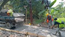 Pekerja tengah meratakan adukan beton dalam proyek rabat jalan lingkungan di Gang H. Ilham, Desa Cikopo, Purwakarta.